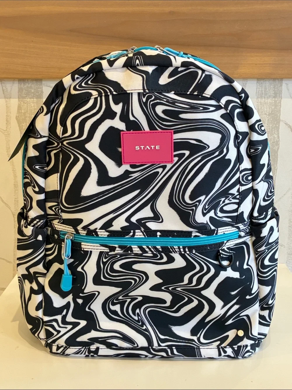 STATE Black & White Swirl Backpack with Pink Logo and Teal Accents
